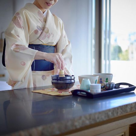 Hotel The Celestine Kyoto Gion Екстер'єр фото A woman in a yukata preparing a Japanese tea ceremony
